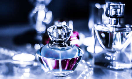 Perfumery, cosmetics branding and luxe concept - Perfume bottle and vintage fragrance on glamour vanity table at night, pearls jewellery and eau de parfum as holiday gift, luxury beauty brand presentの写真素材