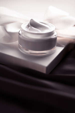 Organic cosmetics, luxe present and natural cosmetology concept - Beauty face cream skin moisturizer, luxury spa cosmetic and natural clean skincare product and holiday gift on dark silkの写真素材