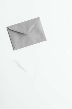 Postal service, newsletter and greeting card concept - Blank paper envelopes on marble flatlay background, holiday mail letter or post card message designの写真素材