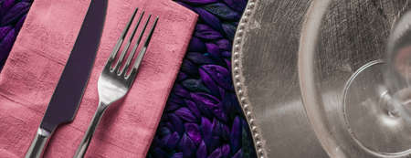 Table scape, menu and interior concept - Holiday table setting with pink napkin and silver cutlery,...