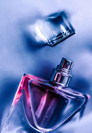 Perfumery, cosmetics and branding concept - Perfume bottle under purple water, fresh sea coastal scent as glamour fragrance and eau de parfum product as holiday gift, luxury beauty spa brand presentの写真素材