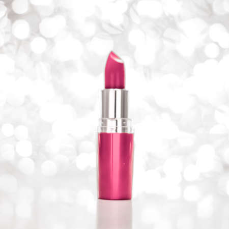 Cosmetic branding, sale and glamour concept - Pink lipstick on silver Christmas, New Years and Valentines Day holiday glitter background, make-up and cosmetics product for luxury beauty brandの写真素材