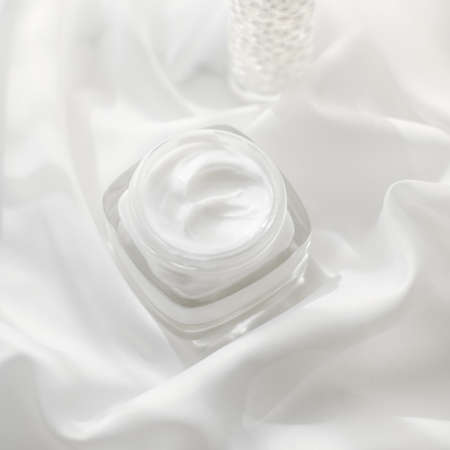 Cosmetic branding, moisturizing and spa concept - Face cream moisturizer jar and serum gel on white...