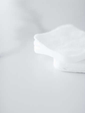 Cosmetology, cleanliness and branding concept - Organic cotton pads on marble background, cosmetics and make-up remover, hygiene and skincare beauty brand product for healthcare and medical designの写真素材