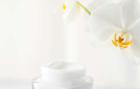 Cosmetic branding, toiletries and spf concept - Face cream moisturizer jar and orchid flower, moisturizing skin care lotion and lifting emulsion, anti-age cosmetics for luxury beauty skincare brandの写真素材
