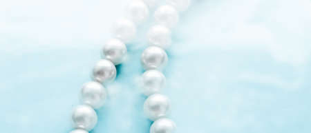 Jewelry, branding and gems concept - Coastal jewellery fashion, pearl necklace under blue water...