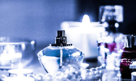 Perfumery, cosmetics branding and luxe concept - Perfume bottle and vintage fragrance on glamour vanity table at night, pearls jewellery and eau de parfum as holiday gift, luxury beauty brand presentの写真素材