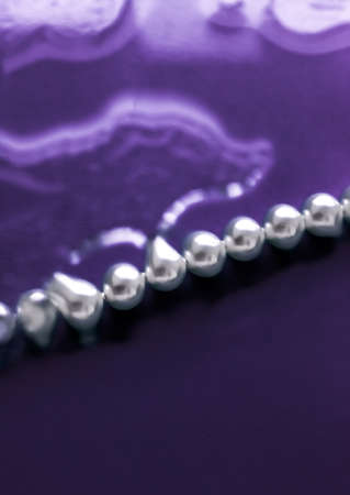 Jewelry, branding and gems concept - Coastal jewellery fashion, pearl necklace under purple water...