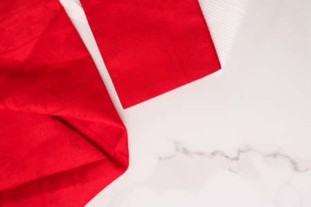 Tableware, material or cloth concept - Kitchen textile on chic white marble background, napkin and towel set, folded fabrics as food styling props for luxury home decor brand, interior designの写真素材