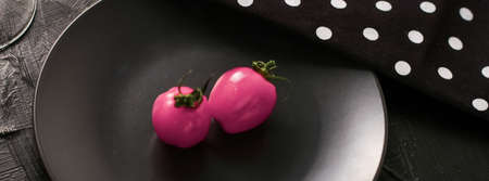 Pink tomatoes on plate, dining table setting - food, drinks and menu concept as holiday background...