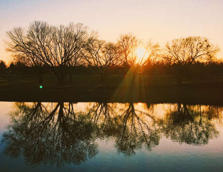 Sunset on the river in park, beautiful autumn natureの写真素材