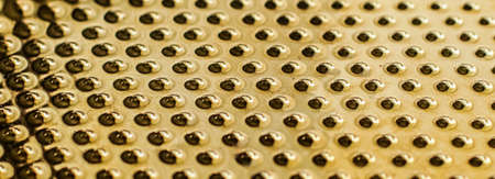 Texture of golden metallic surface as background, materials and interior design conceptの写真素材