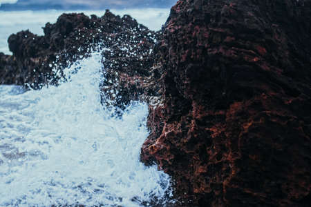 Storm in the ocean, sea waves crashing on rocks on the beach coast, nature and waterscape sceneryの写真素材