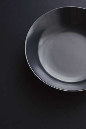 Empty plates on black background, premium dishware for holiday dinner, minimalistic design and diet conceptの写真素材