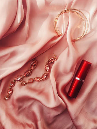 Fashionable and stylish accessories, jewelry and make-up products on pink silk background, beauty and fashion conceptの写真素材