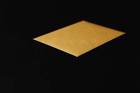 Blank golden paper card on black background, premium business and luxury brand identity mockupの写真素材