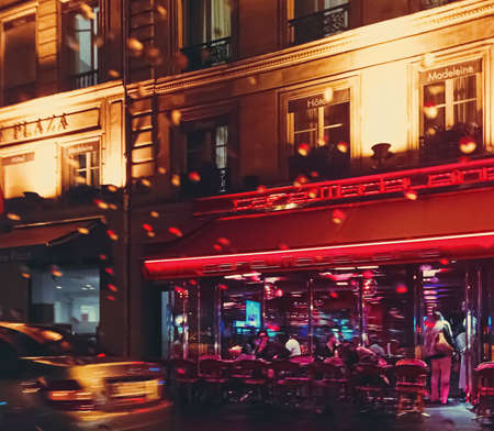 Paris, France circa January, 2020: Historical buildings, restaurants and boutique stores on streets of Paris, France at nightのeditorial素材