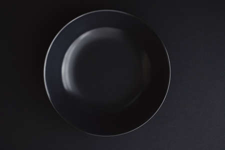Empty plates on black background, premium dishware for holiday dinner, minimalistic design and diet conceptの写真素材