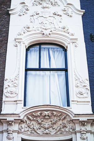 Architectural detail of a building on the main city center street of Amsterdam in Netherlands, european architectureの写真素材