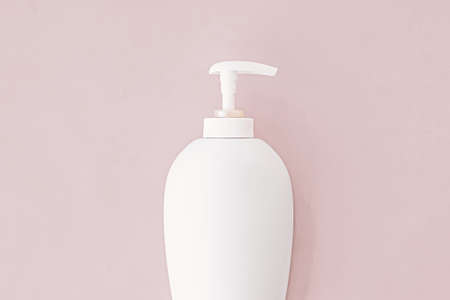 Bottle of antibacterial liquid soap and hand sanitizer on beige background, hygiene product and...