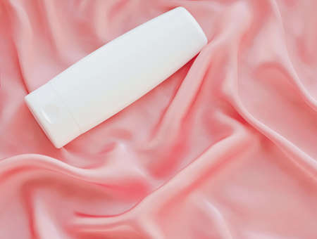 Blank label cosmetic container bottle as product mockup on pink silk background, hygiene and healthcareの写真素材