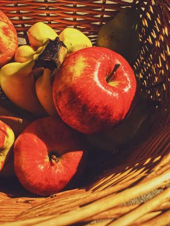 Organic apples, pears and bananas on rustic in a wicker basket, fruits farming and agricultureの写真素材