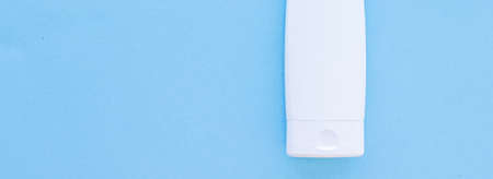 Blank label cosmetic container bottle as product mockup on blue background, hygiene and healthcare