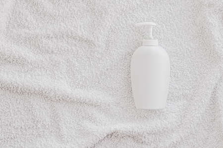 Blank label cosmetic container bottle as product mockup on white towel background, hygiene and healthcareの写真素材
