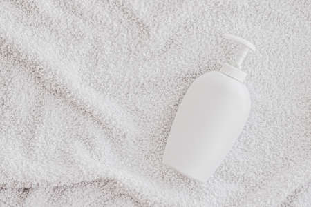 Blank label cosmetic container bottle as product mockup on white towel background, hygiene and healthcareの写真素材
