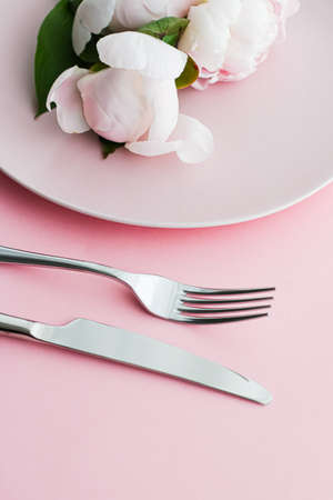Dining plate and cutlery with peony flowers as wedding decor set on pink background, top tableware for event decoration and menu branding designの写真素材