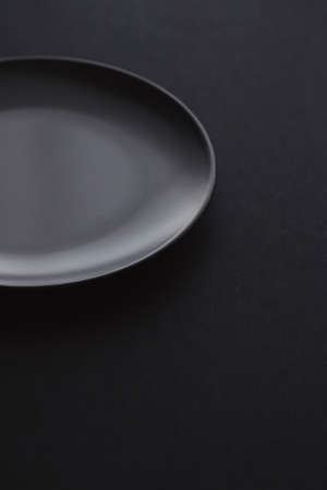 Empty plates on black background, premium dishware for holiday dinner, minimalistic design and diet conceptの写真素材