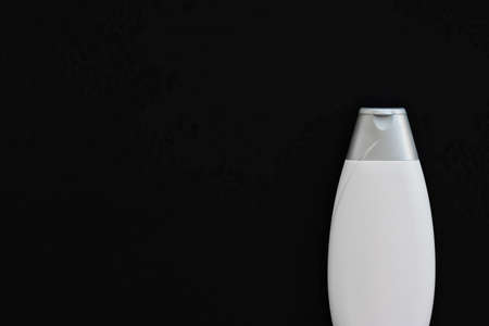 Blank label cosmetic container bottle as product mockup on black background, hygiene and healthcare