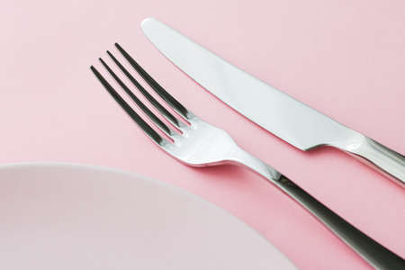 Empty plate and cutlery as mockup set on pink background, top tableware for chef table decor and...