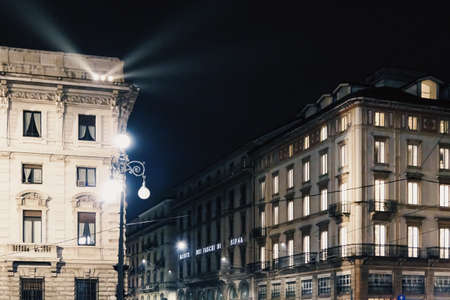 Milan, Italy circa January, 2020: Historical buildings on the city center streets of Milan in Lombardy region in Northern Italy at night, classic European architectureのeditorial素材