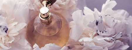 Luxe fragrance bottle as vintage perfume product on violet background and peony flowers, parfum ad...