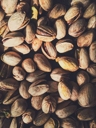 Pistachio nuts on rustic linen background, food and nutrition