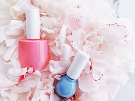 Nail polish bottles on floral background, french manicure and cosmetic branding designの写真素材