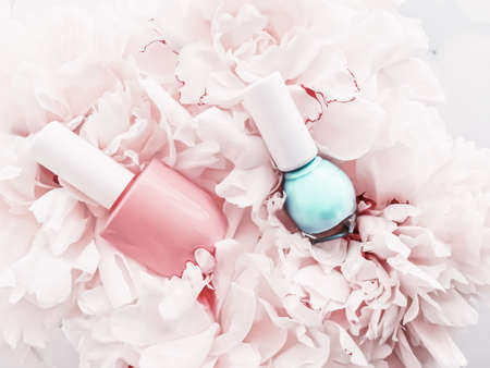 Nail polish bottles on floral background, french manicure and cosmetic branding designの写真素材