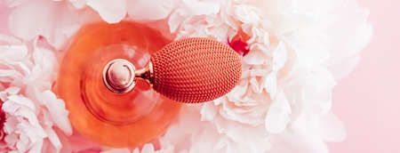 Vintage fragrance bottle as luxe perfume product on background of peony flowers, parfum ad and beauty branding designの写真素材