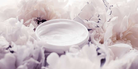 Luxe cosmetic cream jar as antiaging skincare routine product on background of peony flowers, body moisturizer and beauty branding designの写真素材