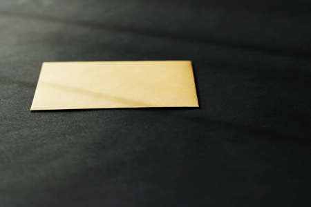 Blank golden paper card on black background, premium business and luxury brand identity mockupの写真素材