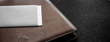 Office desk with briefcase and business card, finance and economy conceptの写真素材