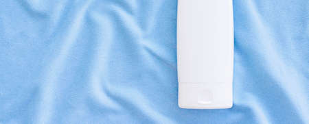 Blank label tube of hand cream or body lotion mockup on silk fabric, beauty product and skin care cosmetics, flatlayの写真素材