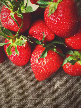Organic strawberries on rustic linen background, fruit farming and agricultureの写真素材