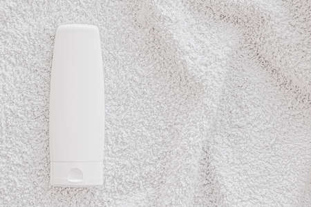 Blank label cosmetic container bottle as product mockup on white towel background, hygiene and healthcareの写真素材