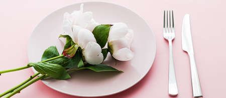 Dining plate and cutlery with peony flowers as wedding decor set on pink background, top tableware...