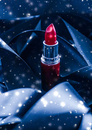 Red lipstick on blue silk and shiny glitter background, luxury make-up and beauty cosmeticsの写真素材