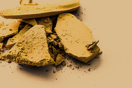 Yellow eye shadow powder as makeup palette closeup, crushed cosmetics and beauty textures