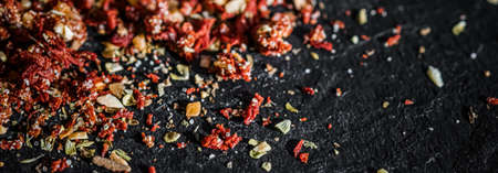 Blurred Dried tomato and chilli pepper closeup on luxury stone background as flat lay, dry food spices and recipe ingredientsの写真素材