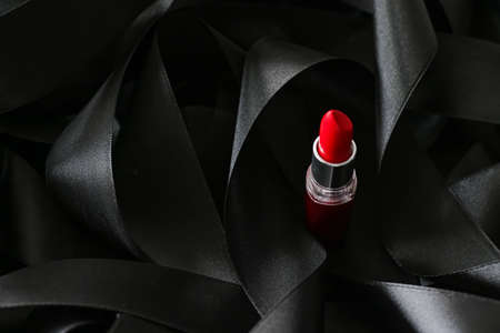Red lipstick on black silk background, luxury make-up and beauty cosmeticsの写真素材
